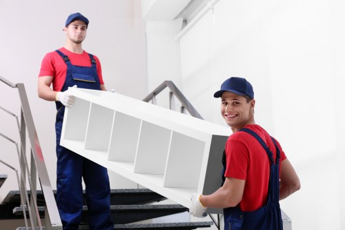Man and van staff using safe lifting techniques outdoors