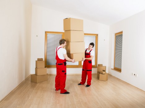 House removal team carrying furniture during a move in Kingstonuponthames