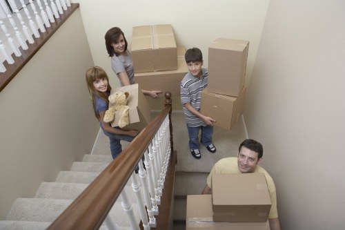 Specialist movers preparing a piano for safe transport in a Kingston home